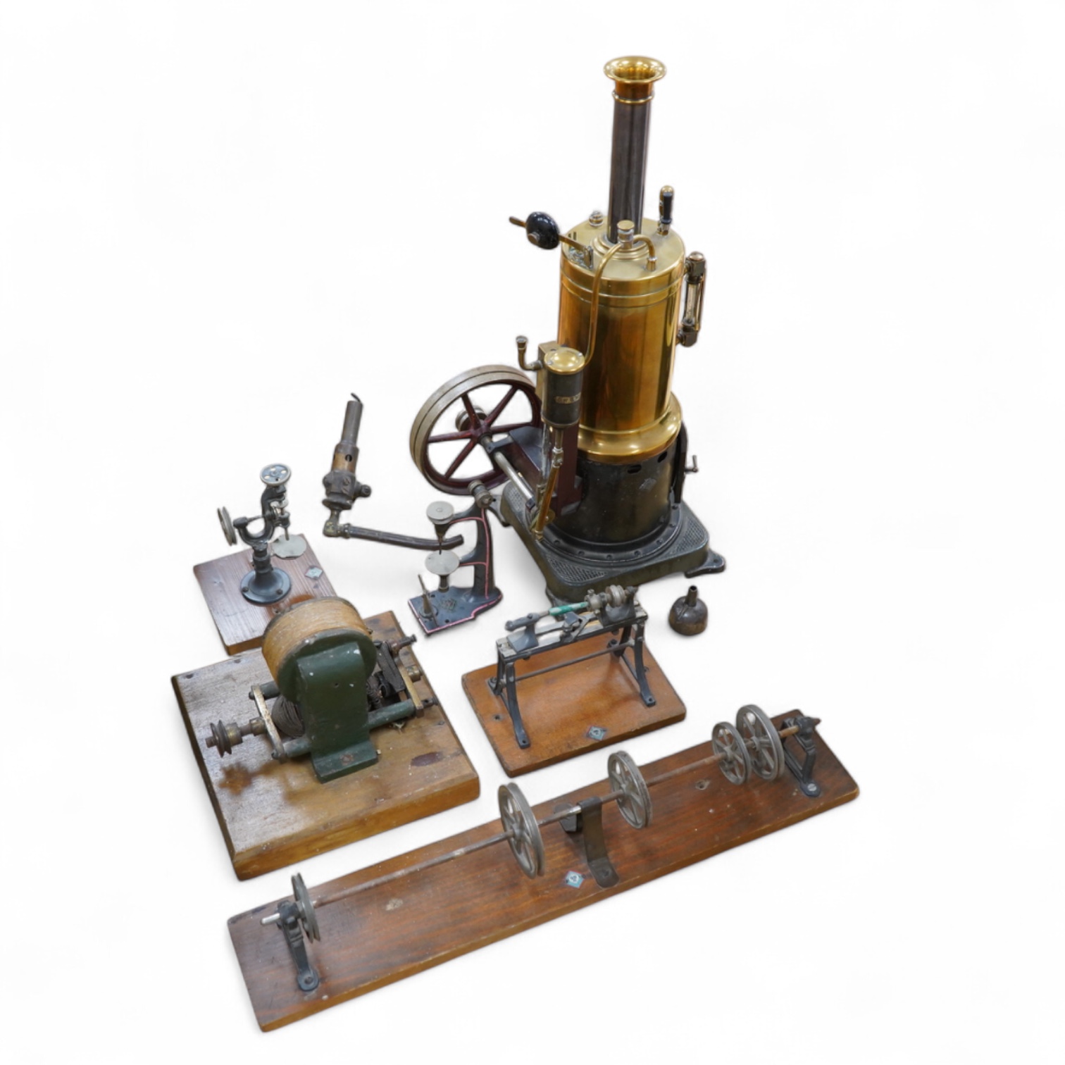 An early 20th century Bing live steam single cylinder vertical stationary engine, of brass, tinplate and cast iron construction, 38cm high, 10.5cm diameter flywheel, complete with the burner, together with a steam plant